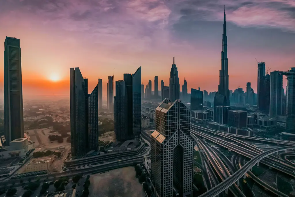 Dubai from the air at sunrise, the Burj Khalifa clear of the towers around it