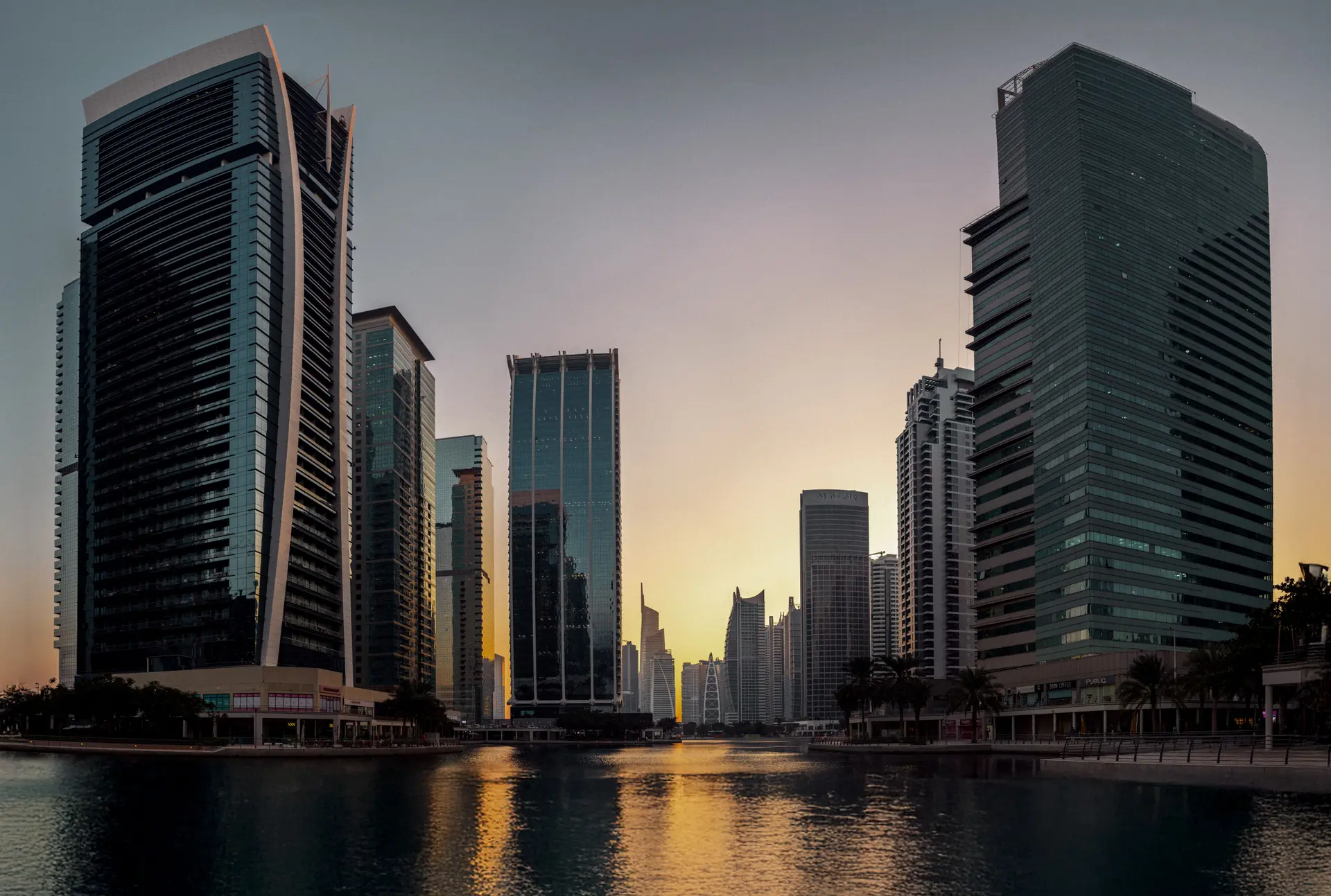 The Business Bay towers at sunset, reflected in the water