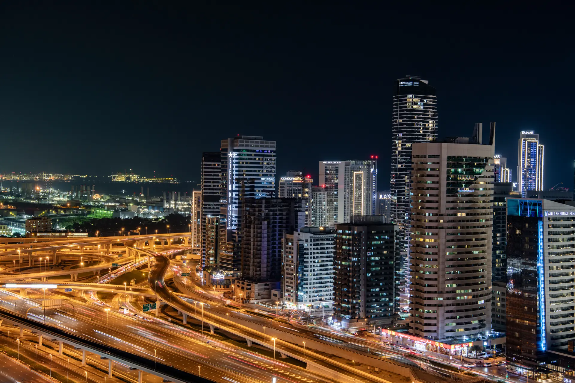 Dubai at night, lit towers above the traffic on the highways below
